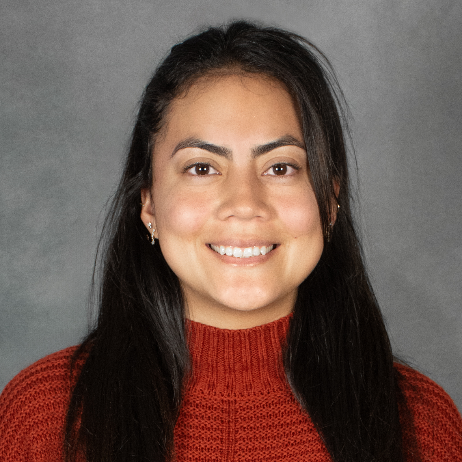 Woman with long brown hair wearing red sweater