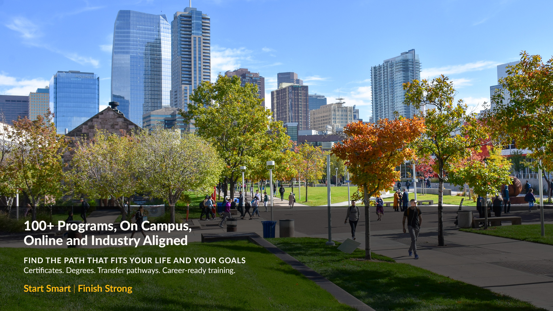 Denver skyline with students walking on the auraria campus surrounded by trees in the fall 