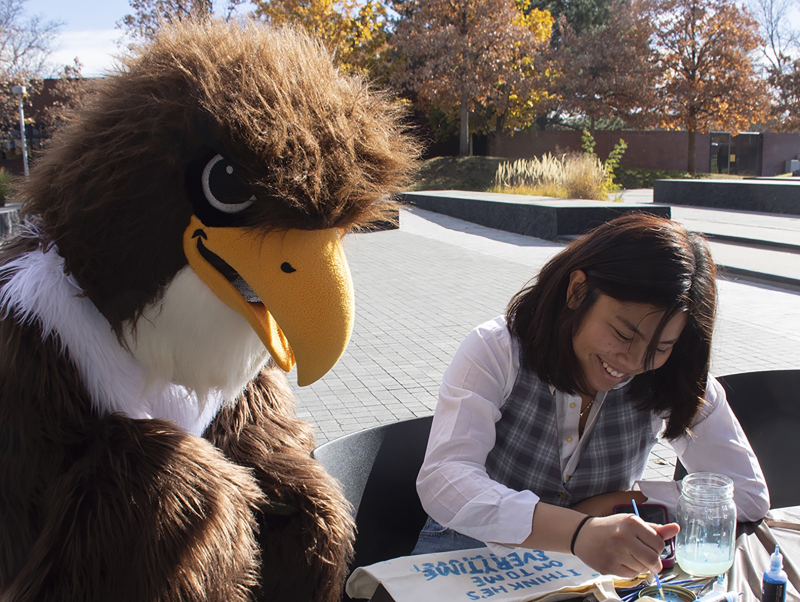 CCD mascot and student outside laughing 