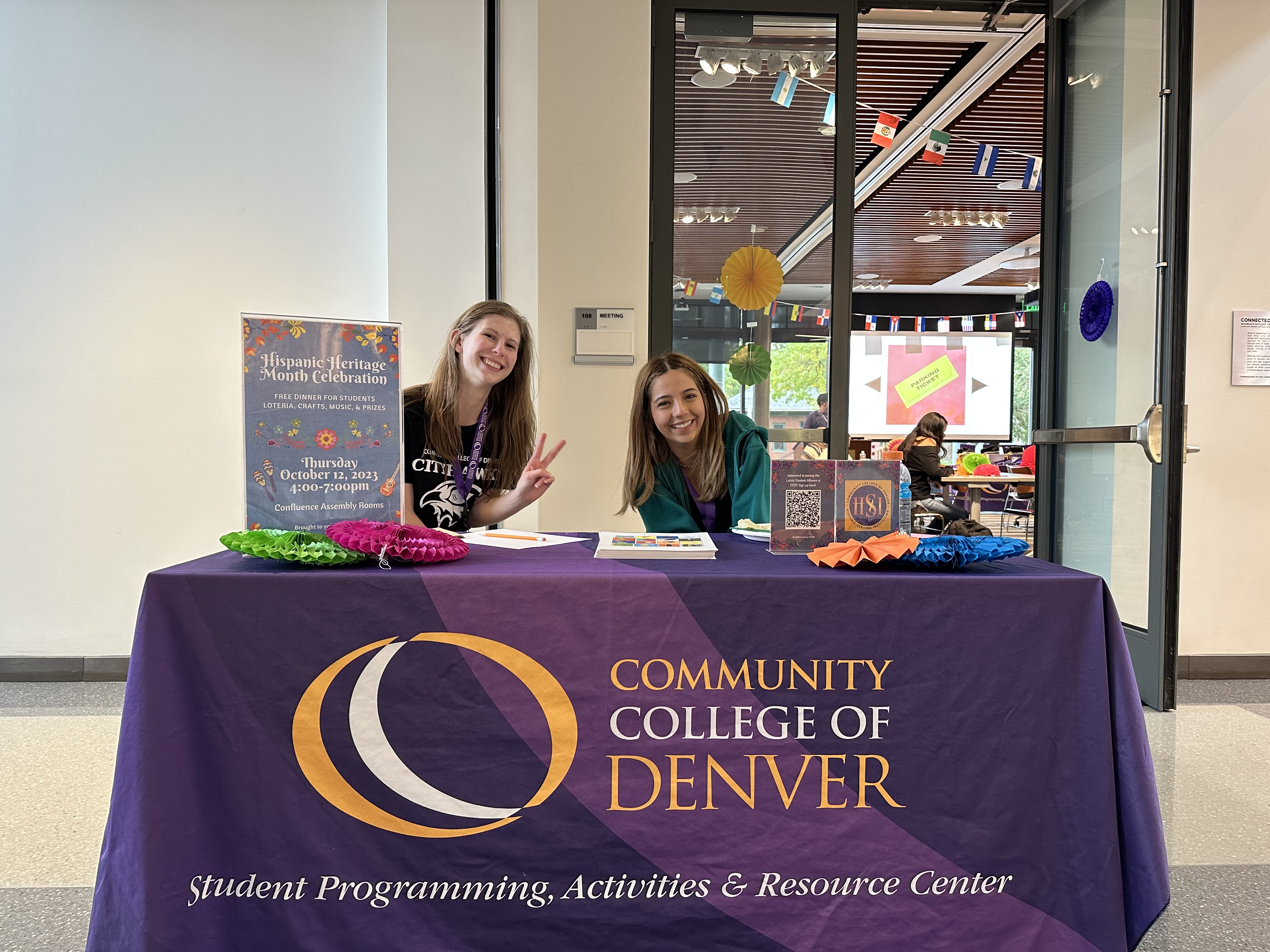 two women at a CCD table smiling at an event