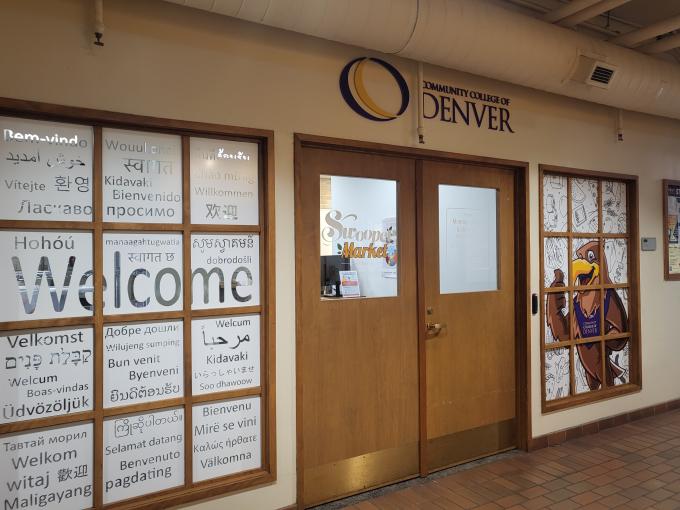 front door of the swooper market in the tivoli, with glass that says welcome 