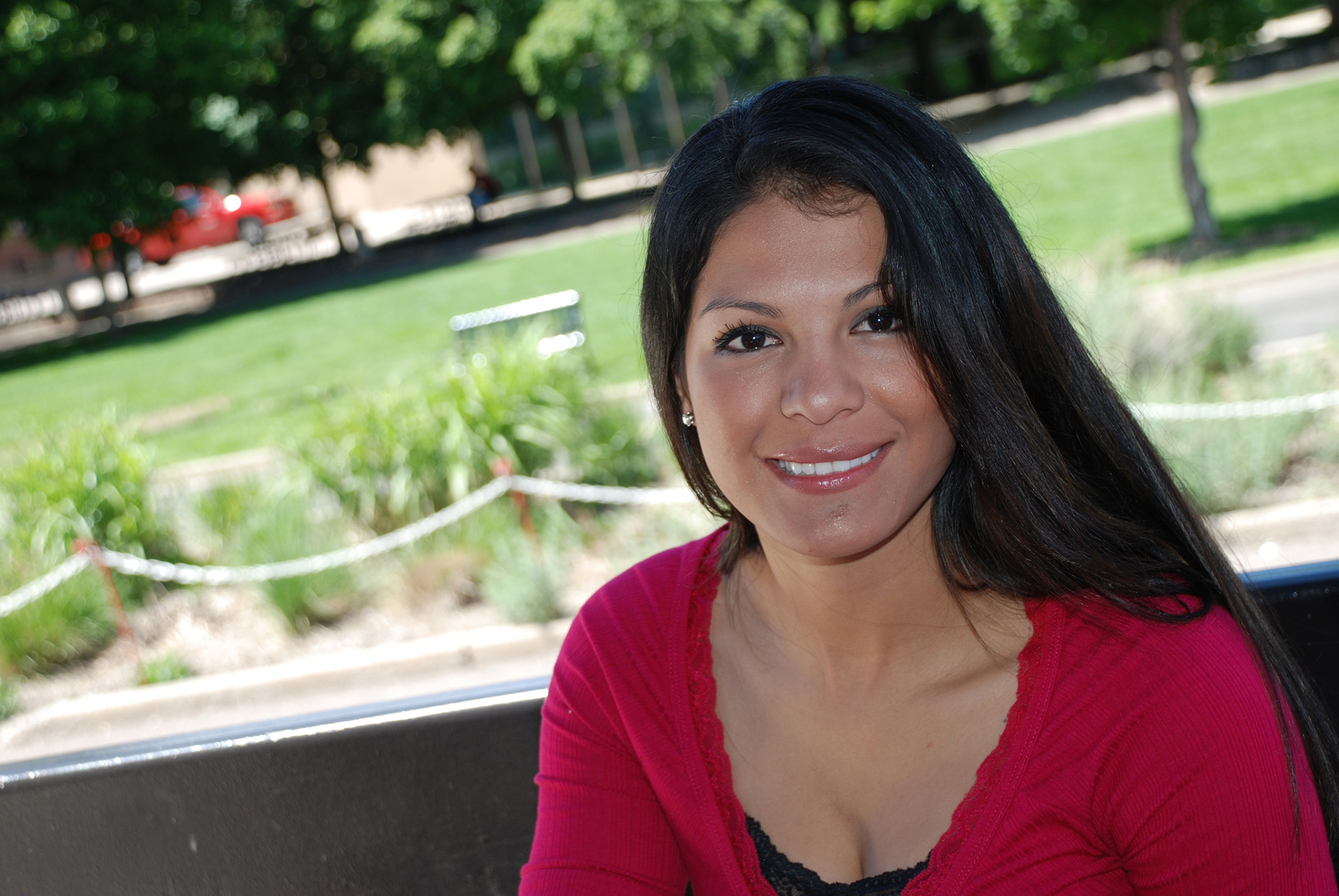 Smiling female CCD student wearing a red shirt