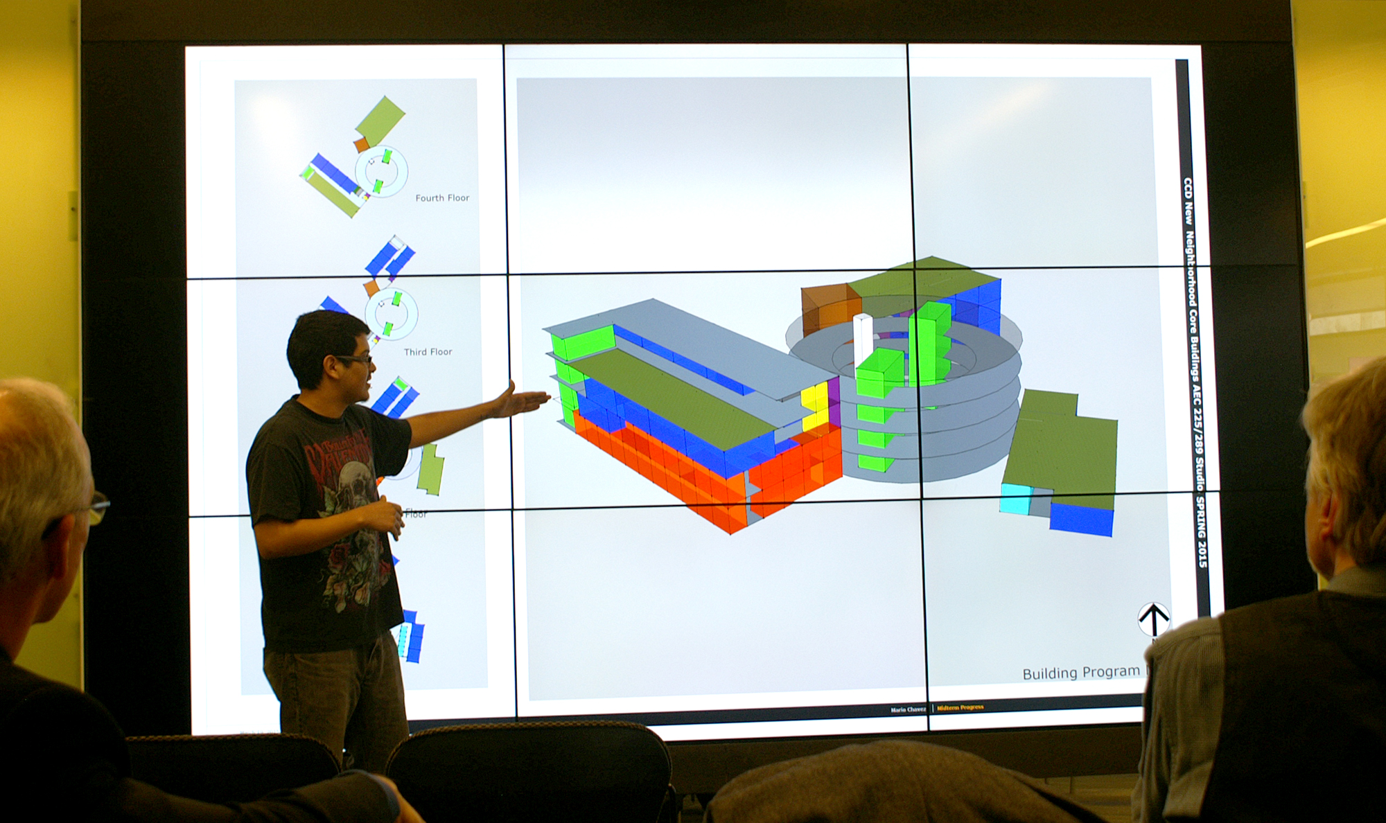 CCD Architecture Student Presents in the Auraria Campus Library Discover Wall image of student in front of large screen