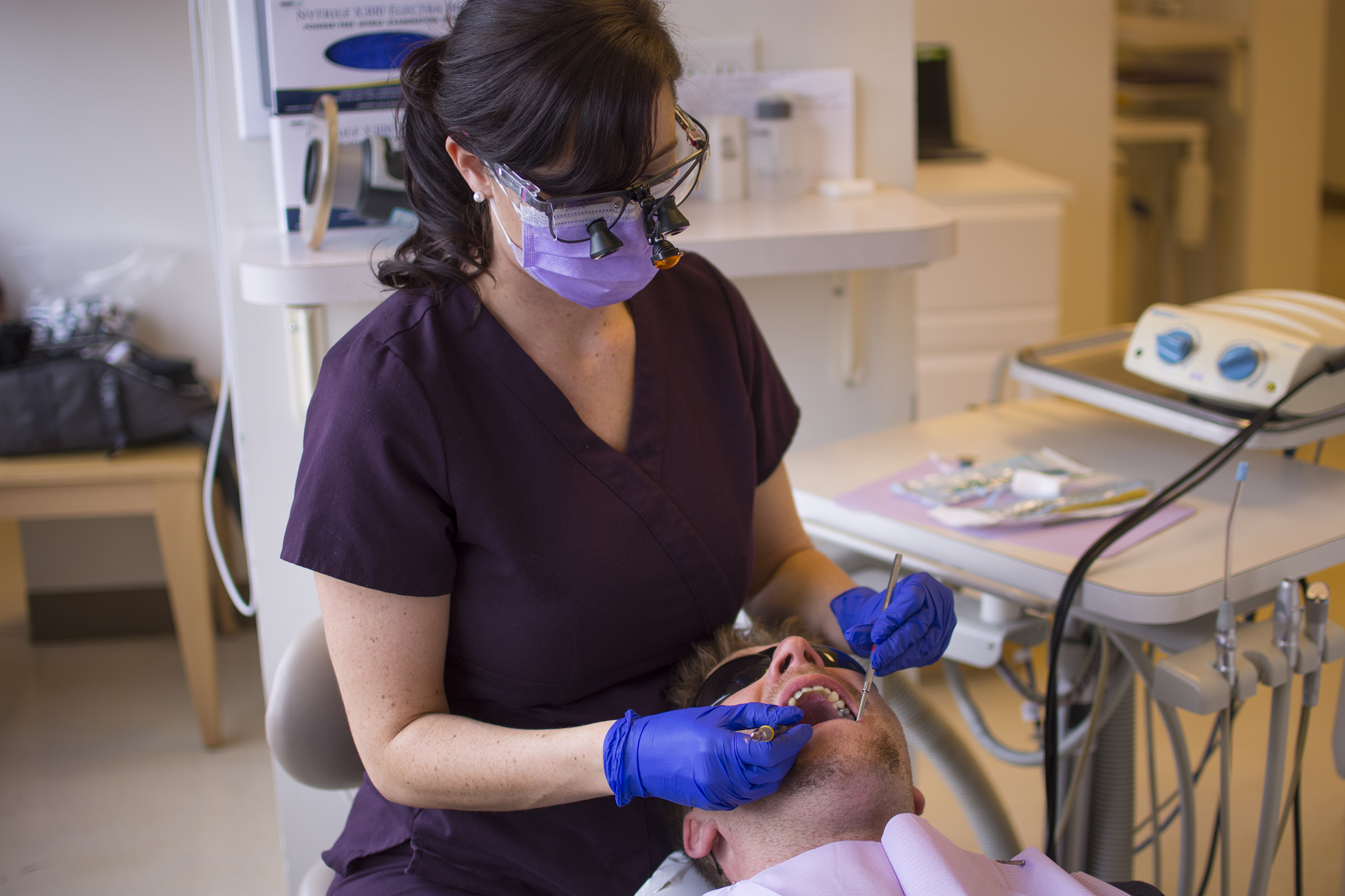 dental hygienist working on a man