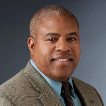 headshot of man in a suit