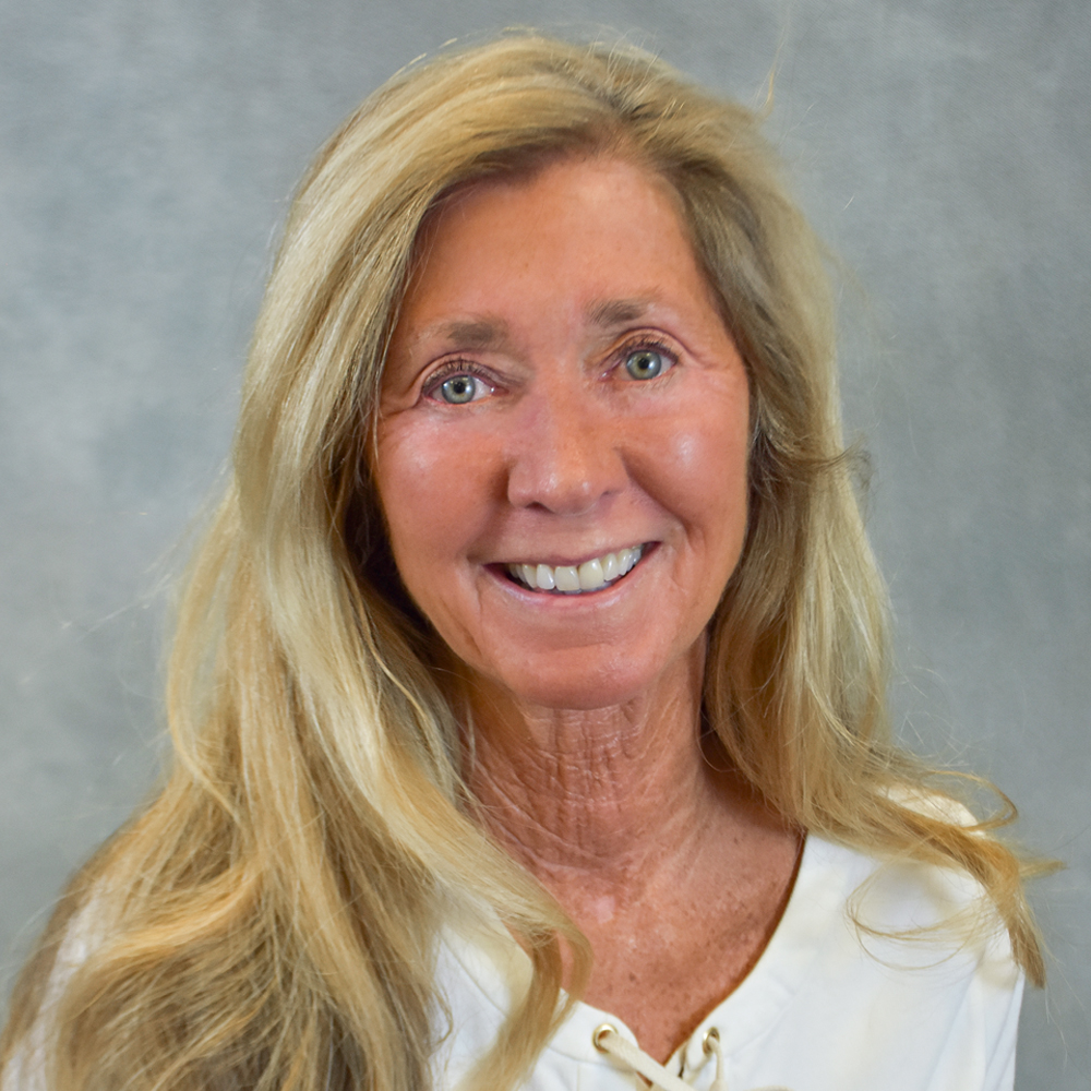 Woman with long hair wearing a white shirt.