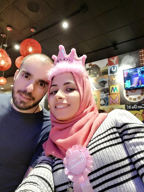 muslim female student standing with her husband smiling