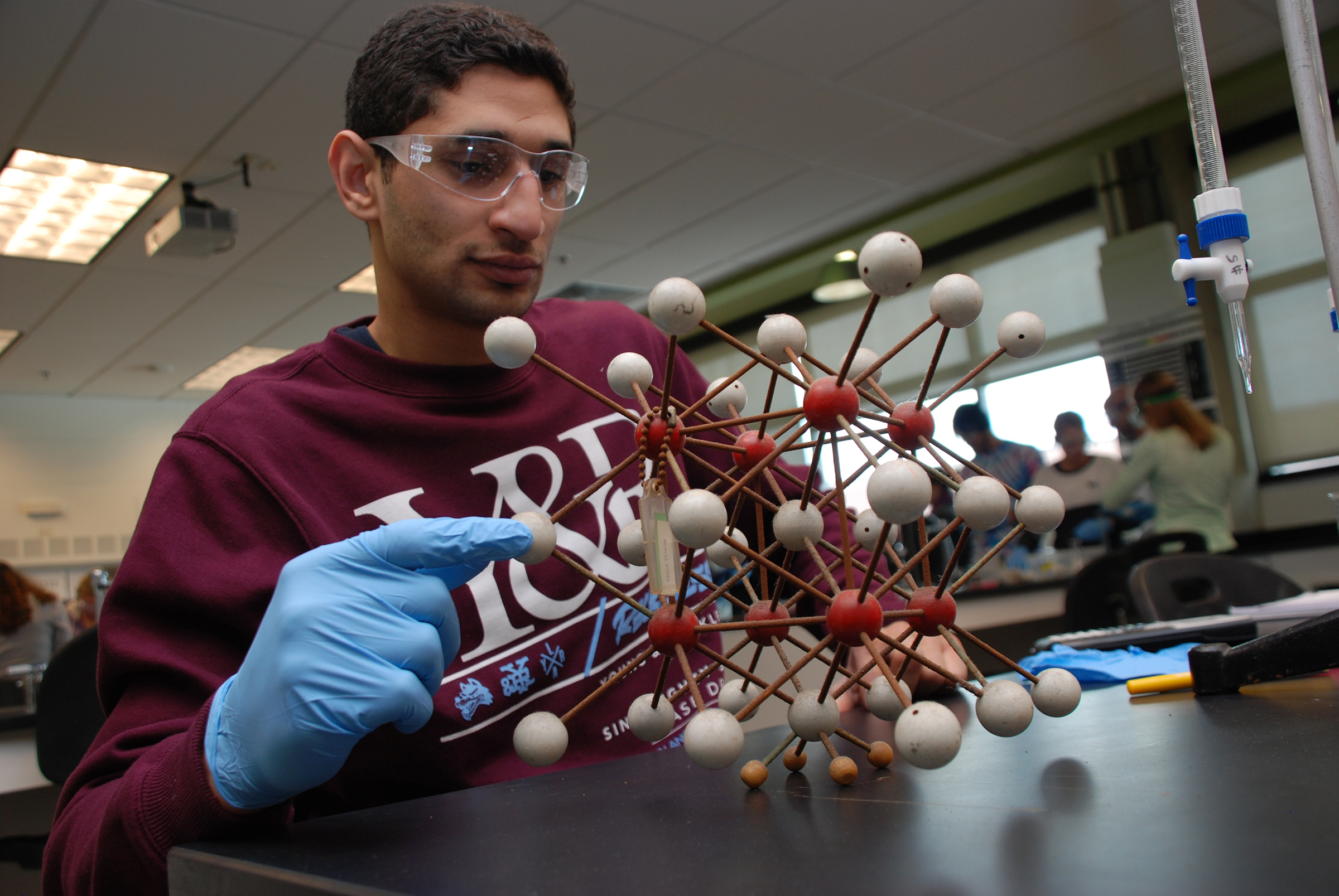 man holding a molecular model