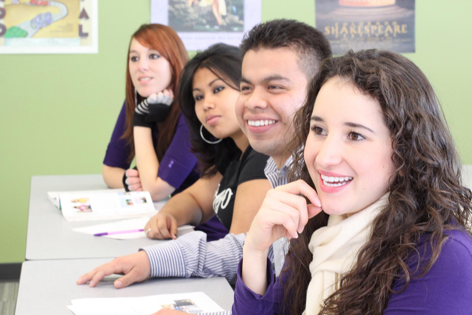 Four CCD students smiling at professor