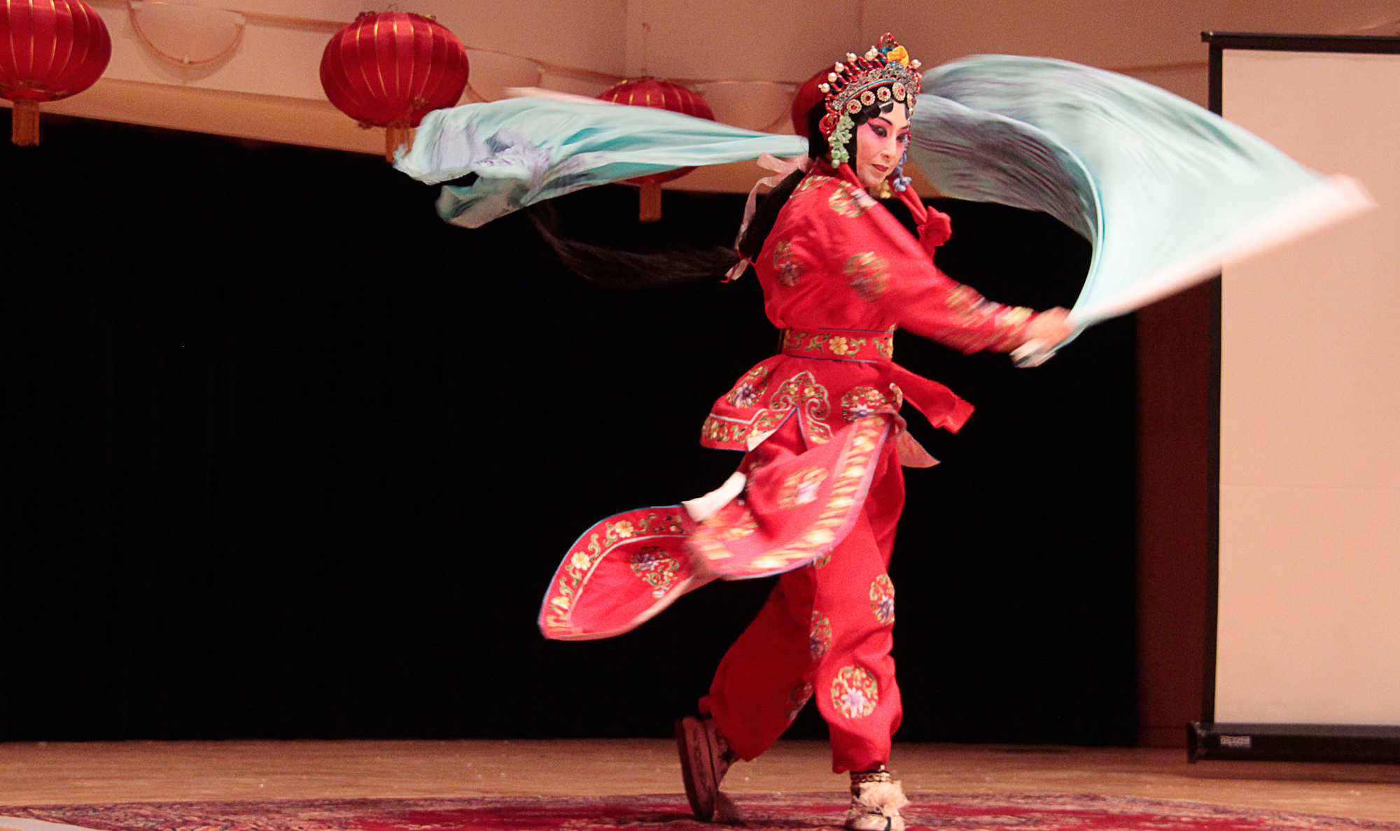 chinese woman dressed in red dancing on stage