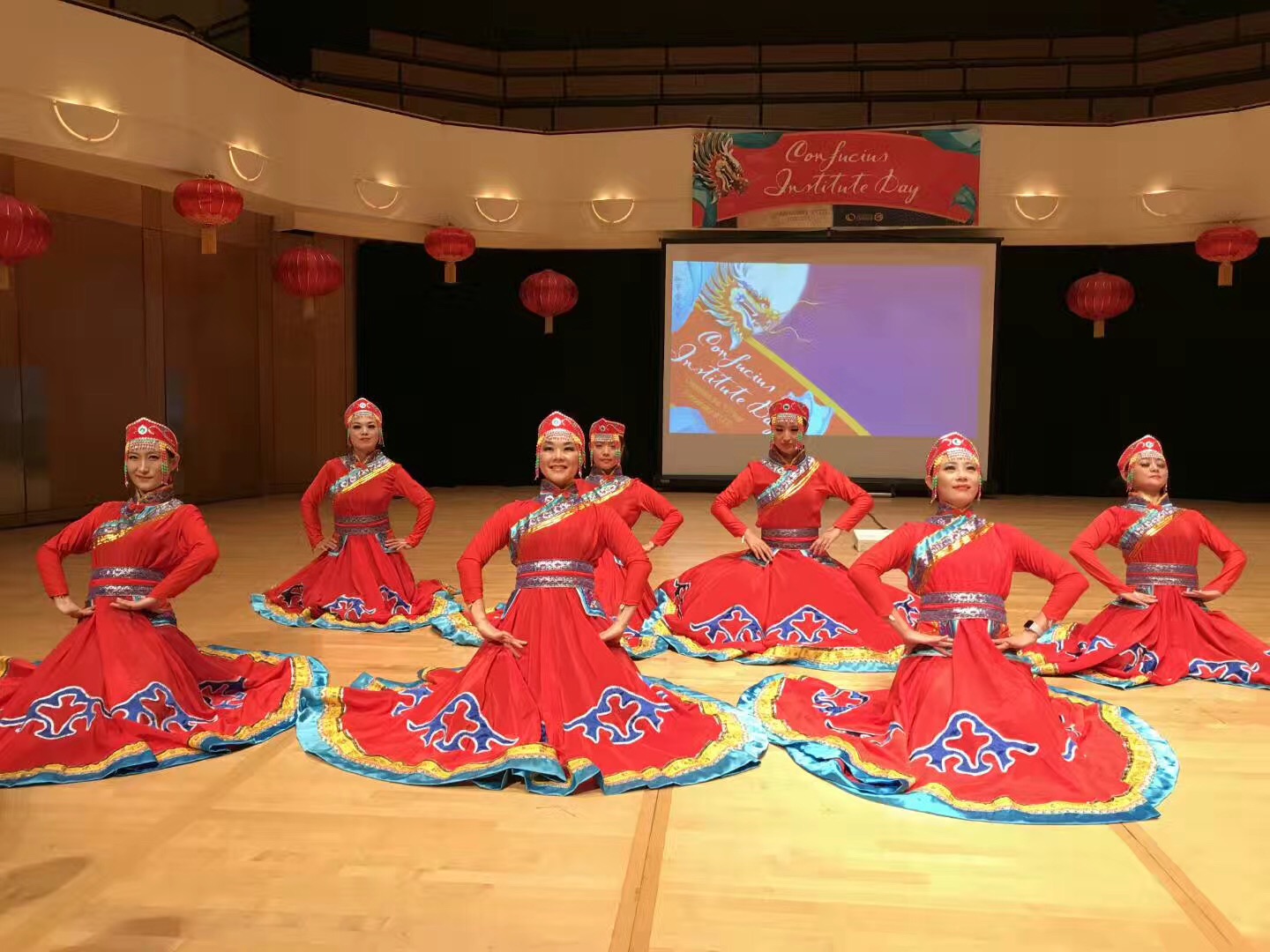 female chinese dancers in matching red dresses