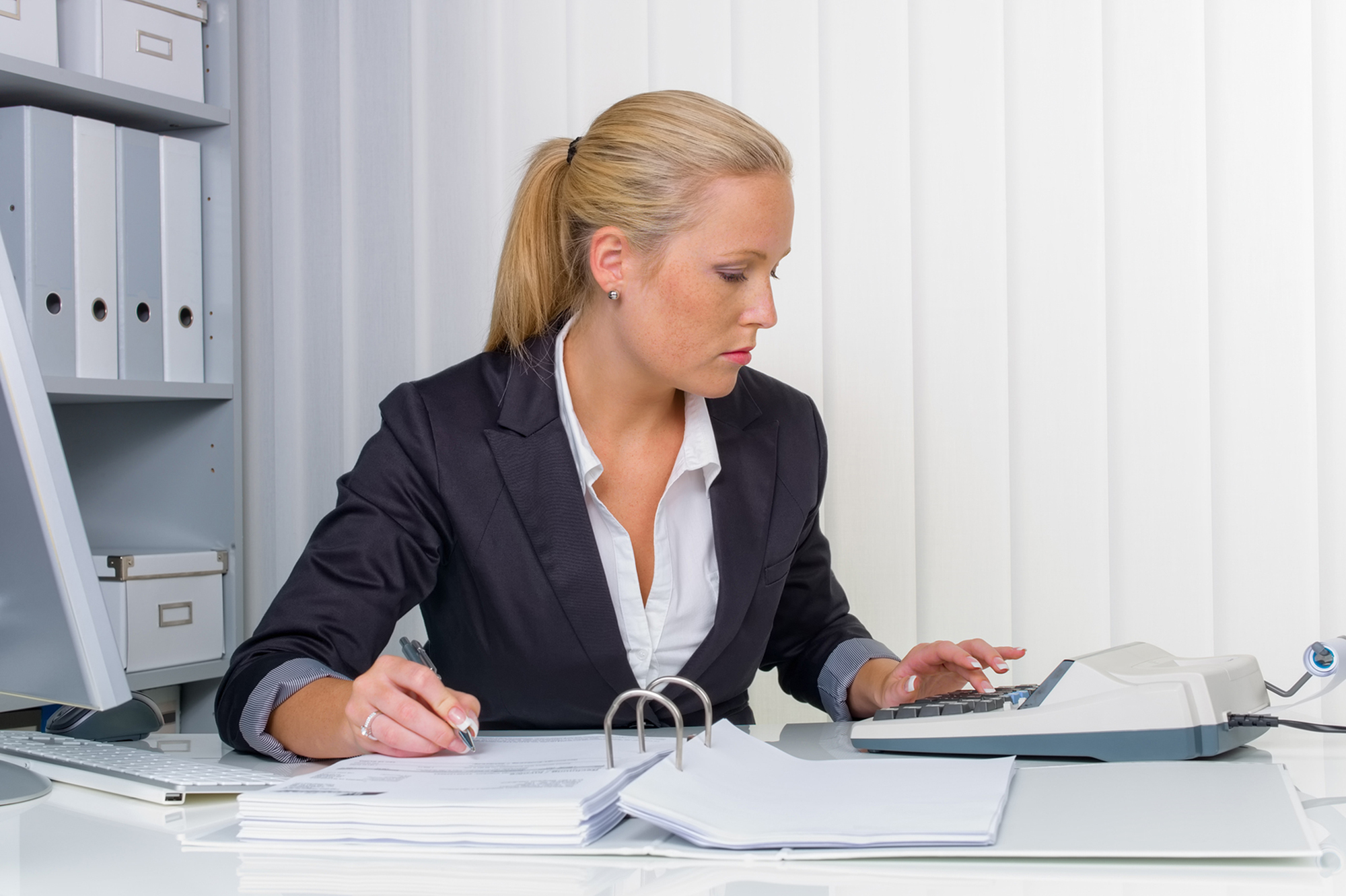 Female accountant using an adding machine