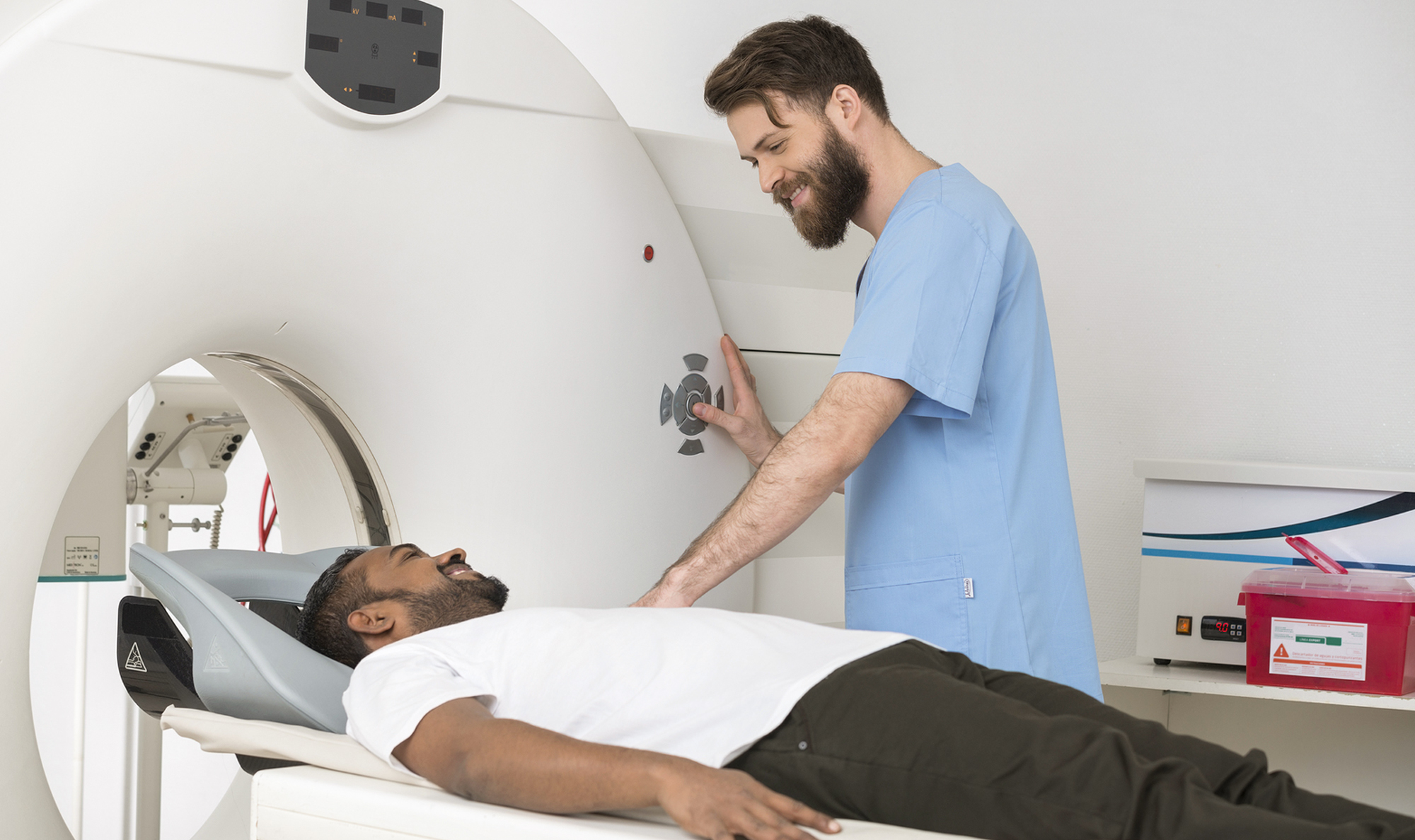 Increase your employment options and earning potential by adding this post primary certification to your name. man in scrubs giving man a c-scan