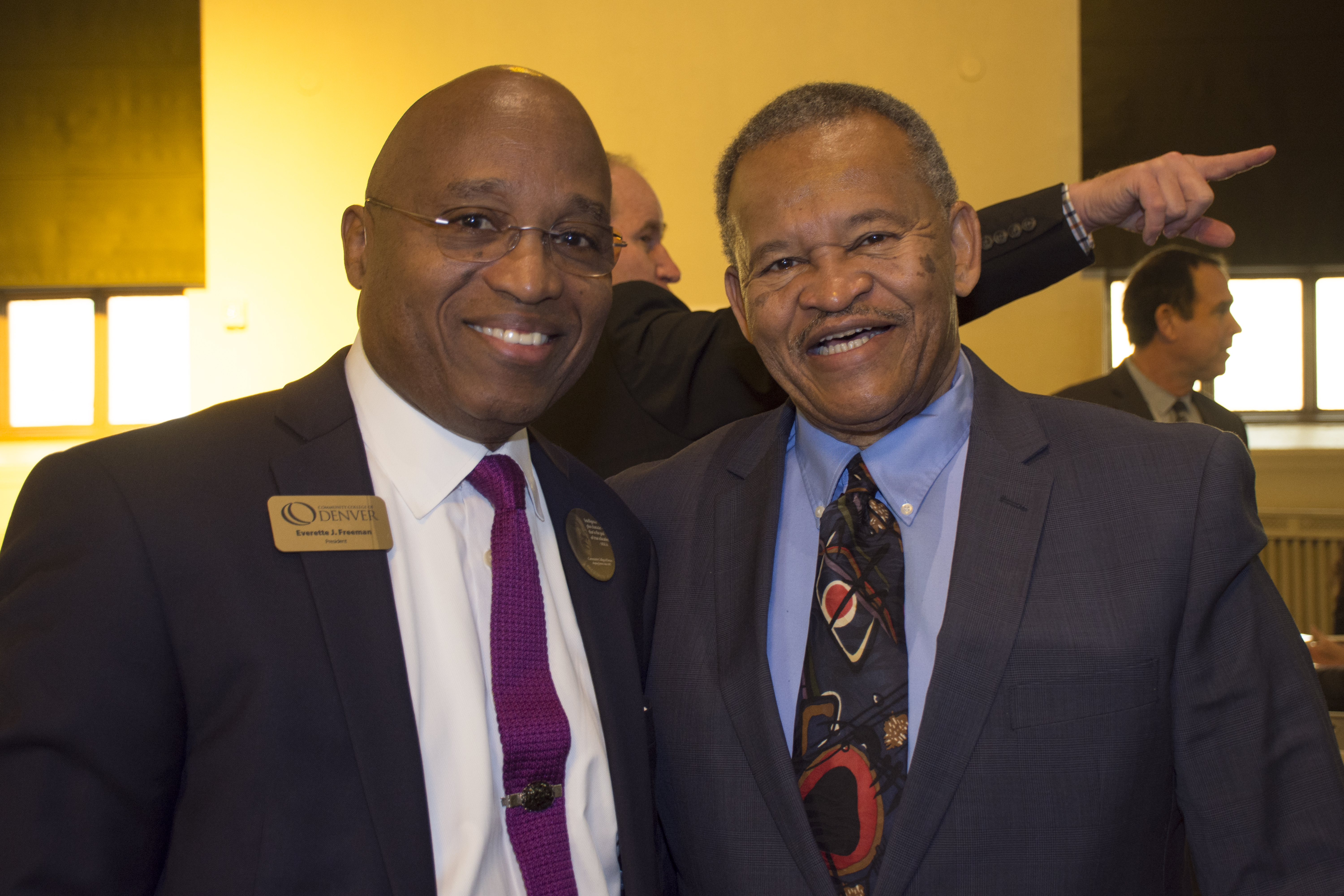 two men wearing suits at an awards ceremony