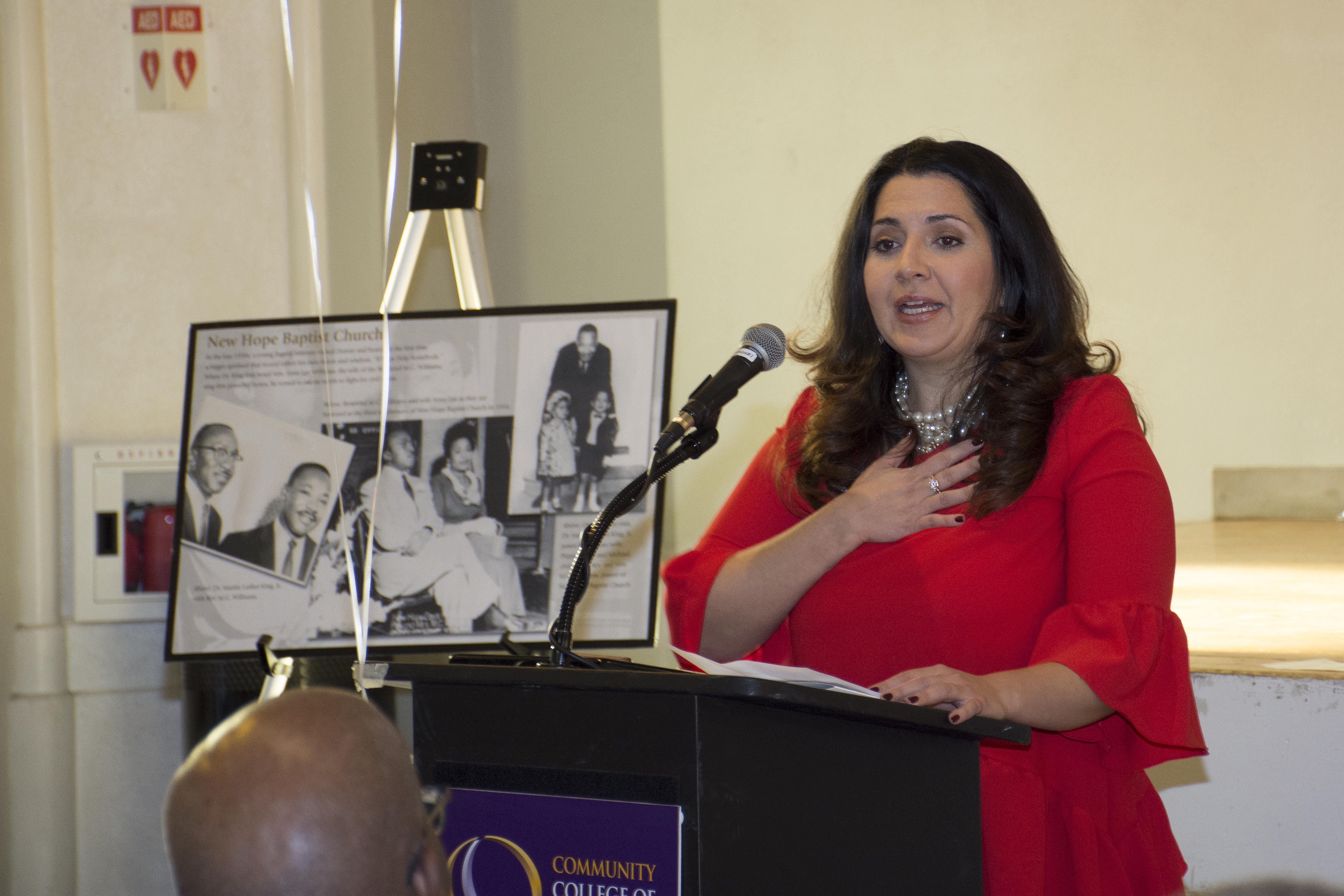 woman in red giving a speech