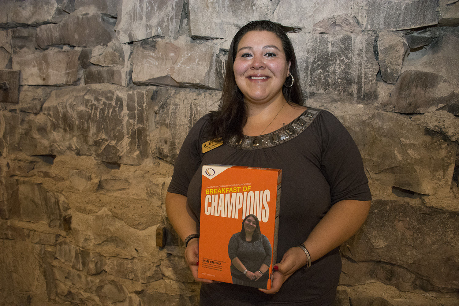 CCD Associate of Arts – Communication Student Angel Martinez, Assistance League of Denver Scholarship,Boundless Opportunity Scholarship and Freda T. Roof Memorial Scholarship Fund young woman holding a box with her picture on it
