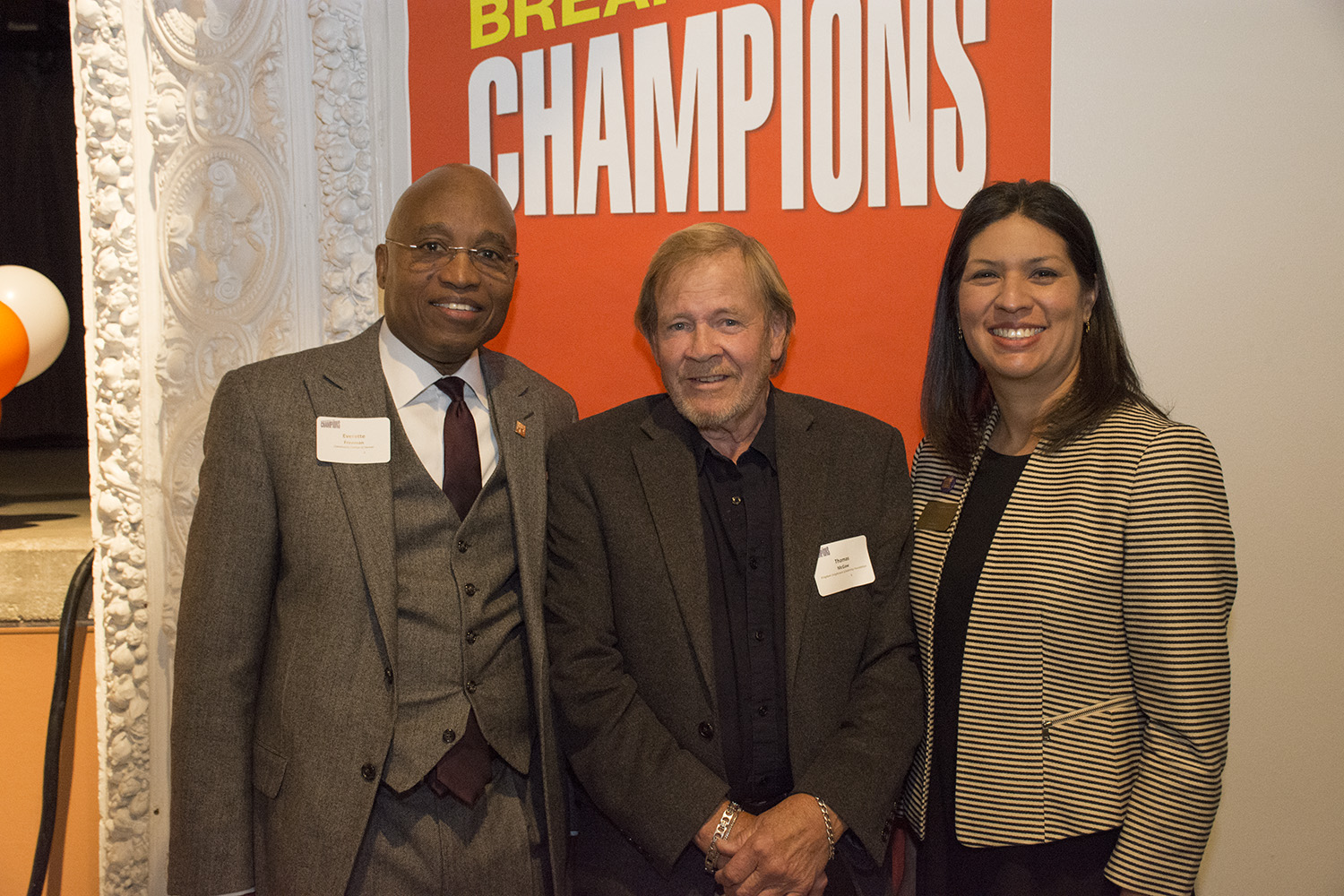 three people pose at an award function