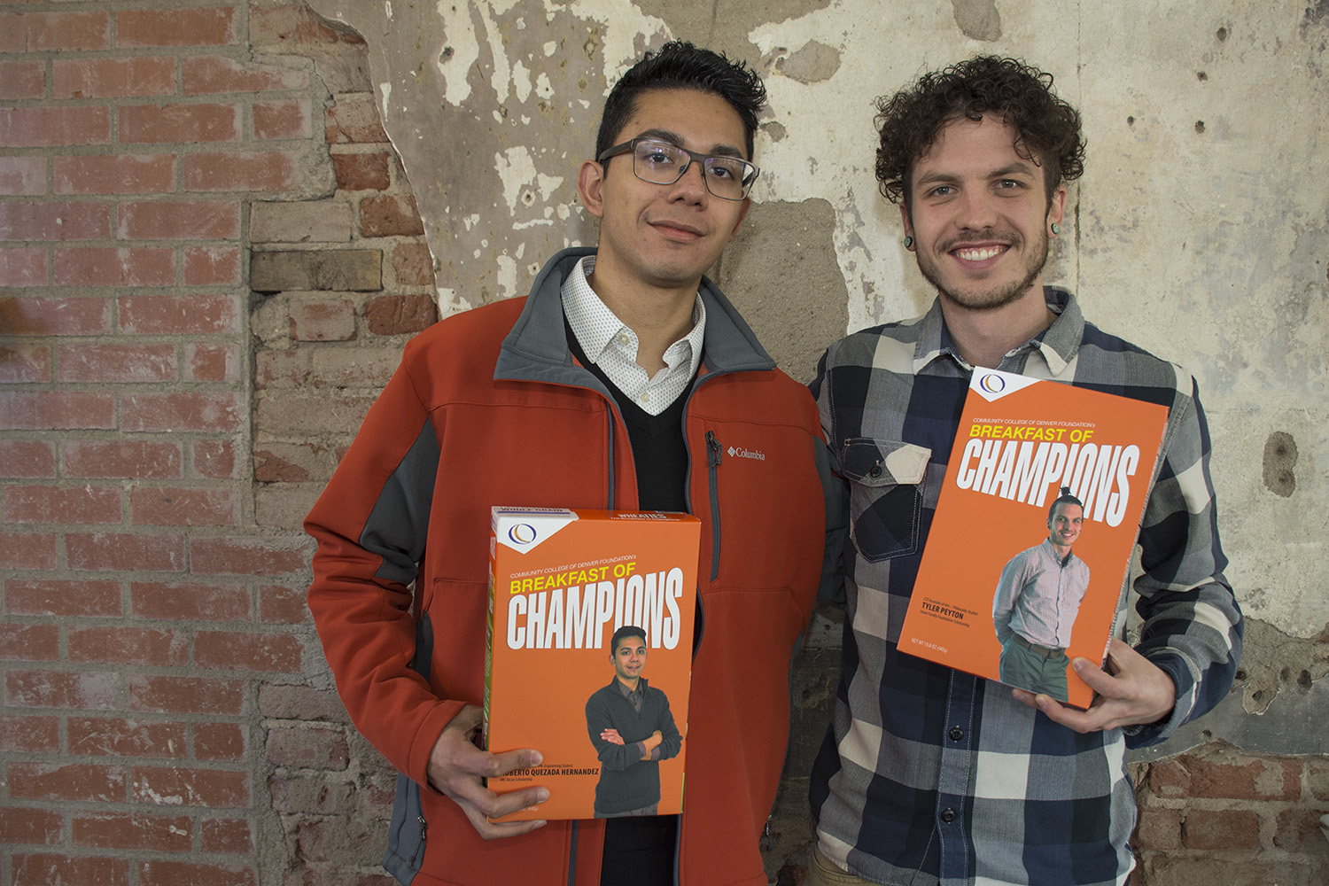 two young men holding boxes with their pictures