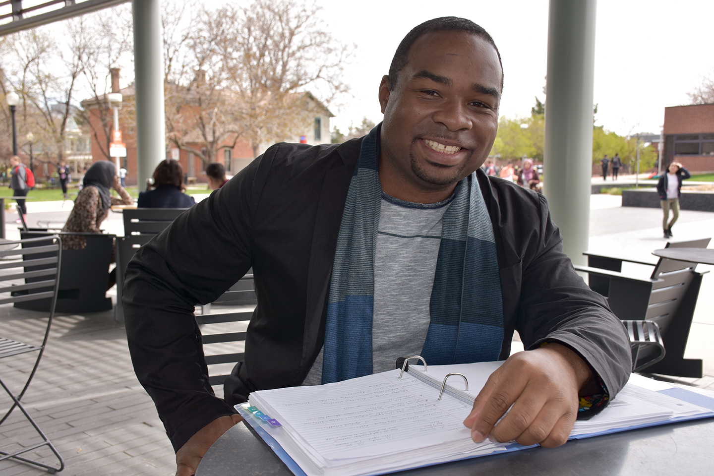 black man at a table smiling