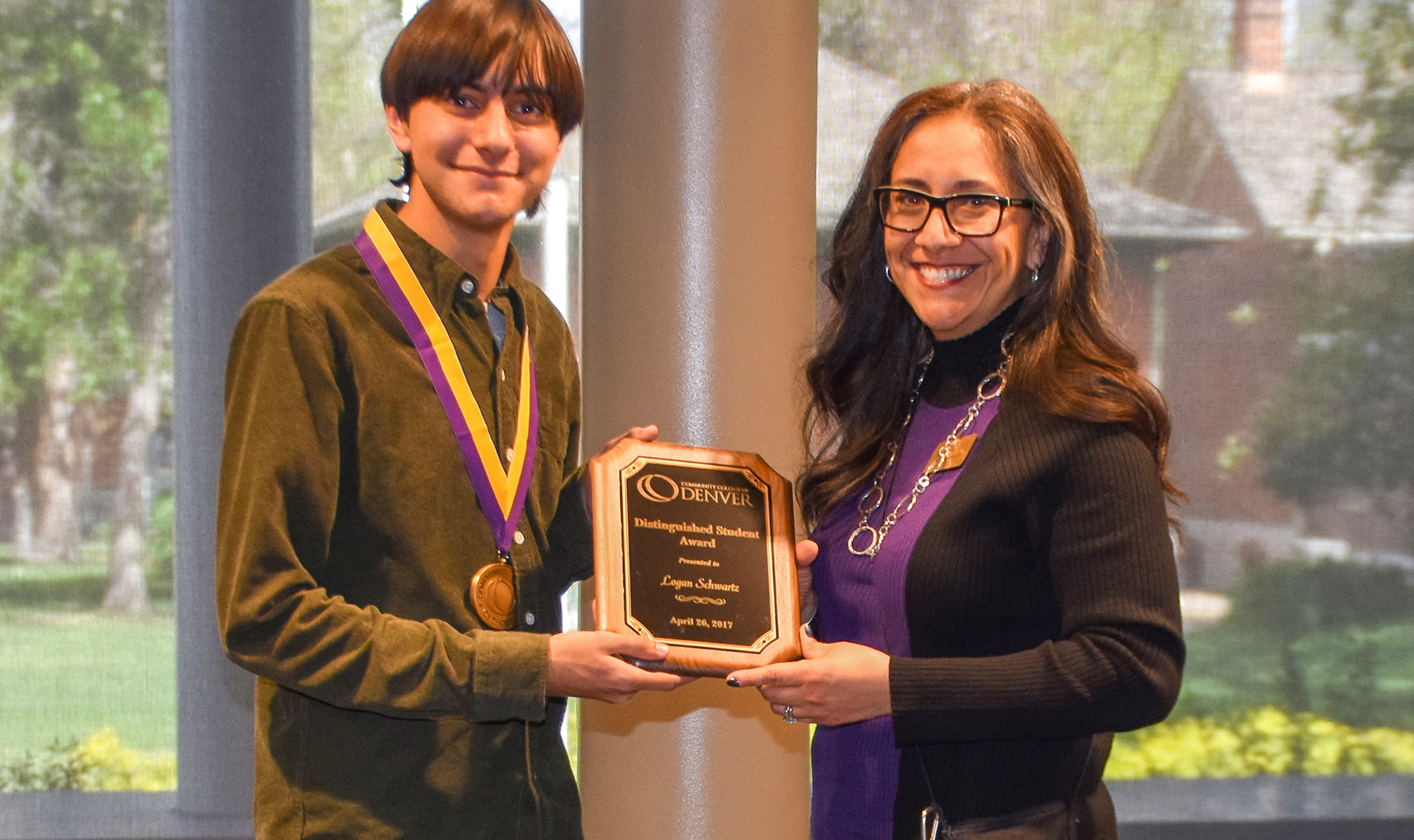 Distinguished Student Award Logan Schwartz with CCD VP Judi Bonaquisti young man being presented the Distinguished Student Award