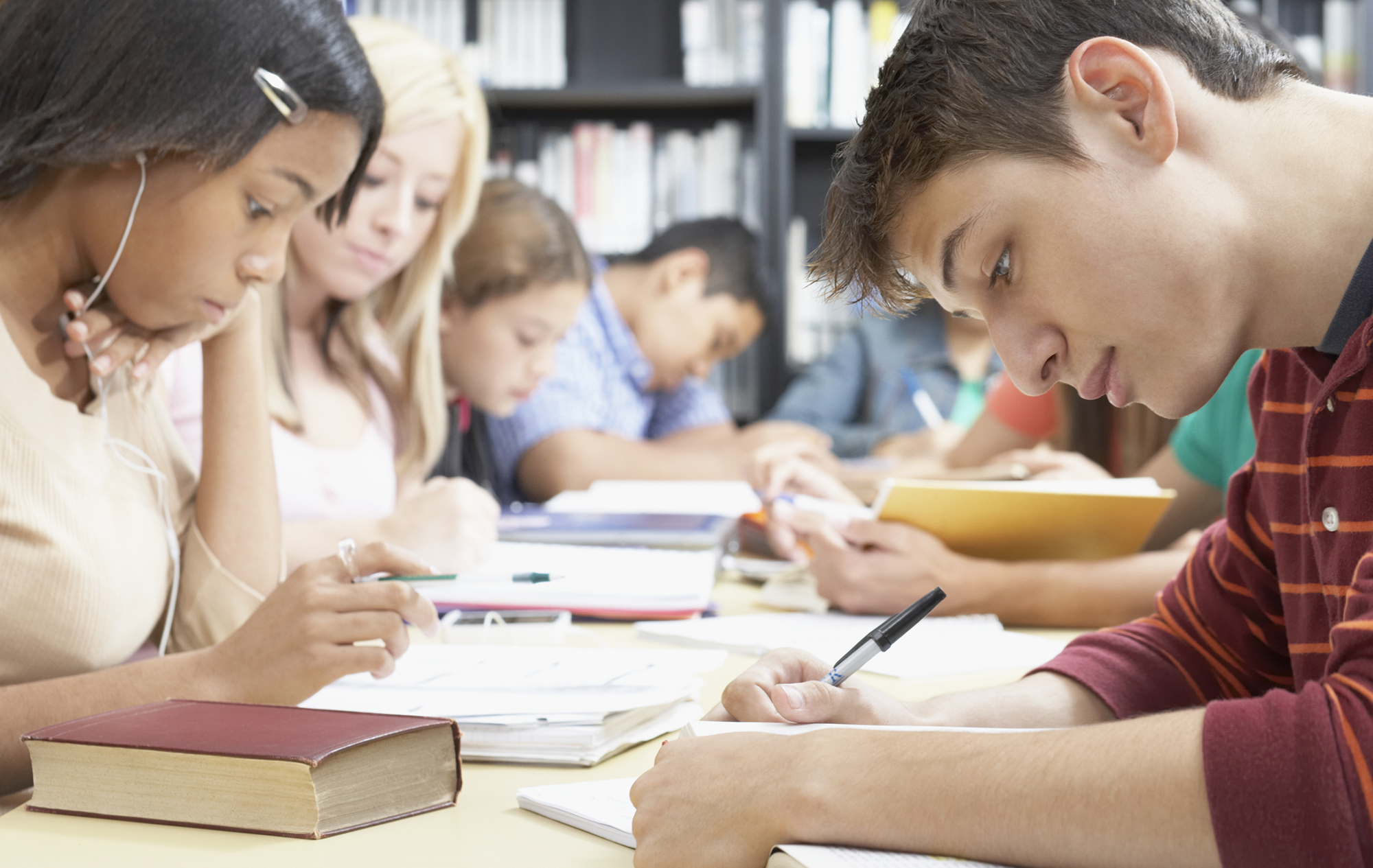 Group of students studying at a long table