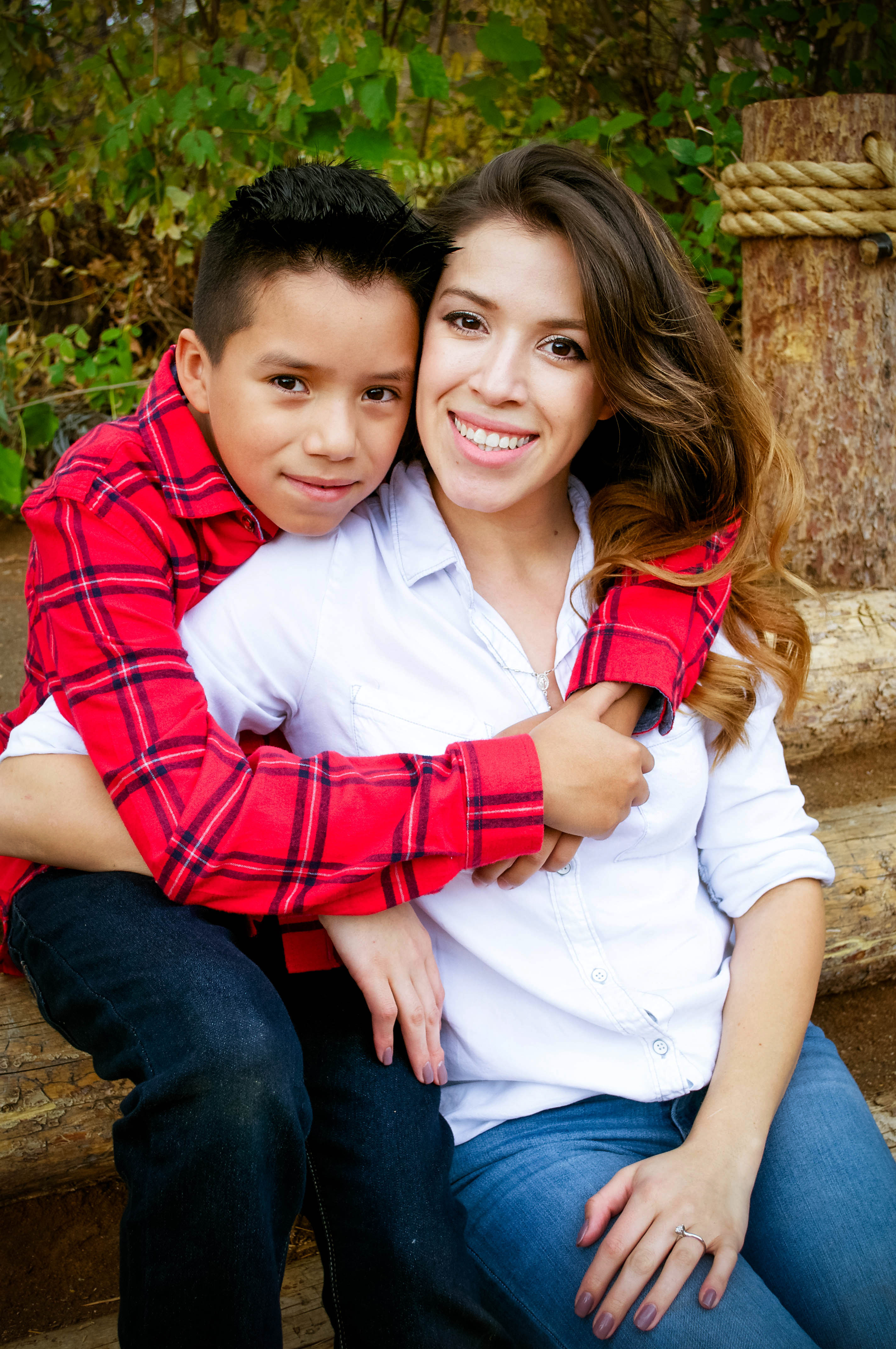 young man in red shirt hugging his mom