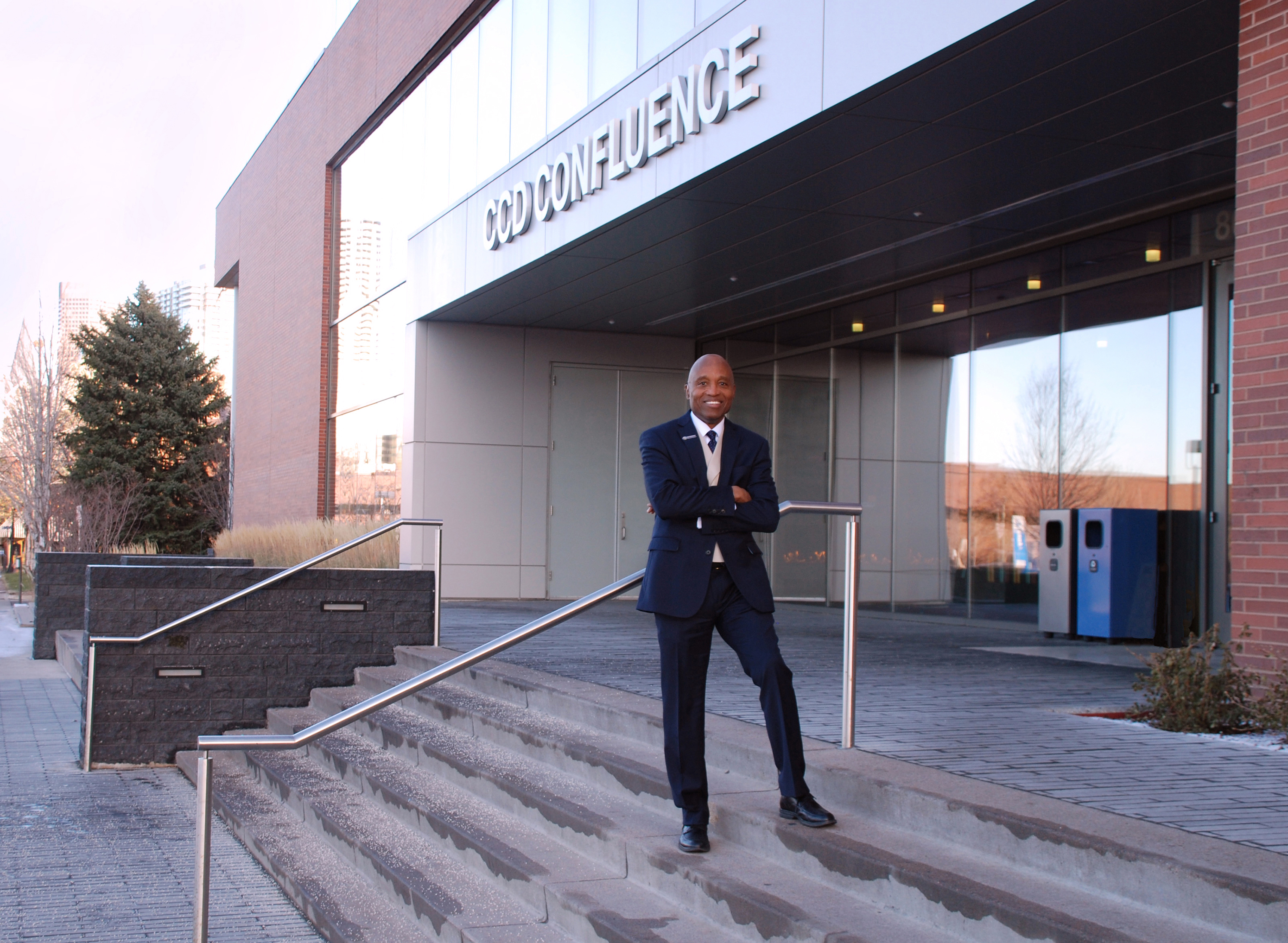 a man standing on the steps in front of a building