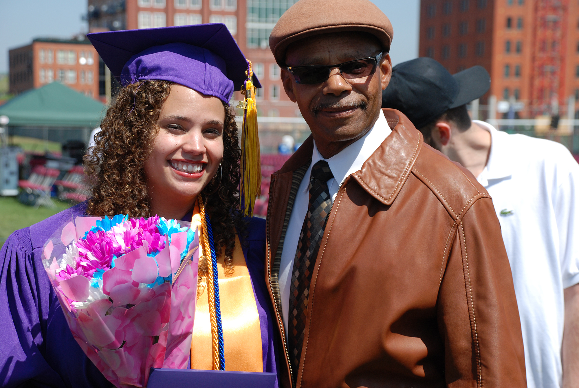 Female CCD graduate standing next to a man after Commencement Ceremony.