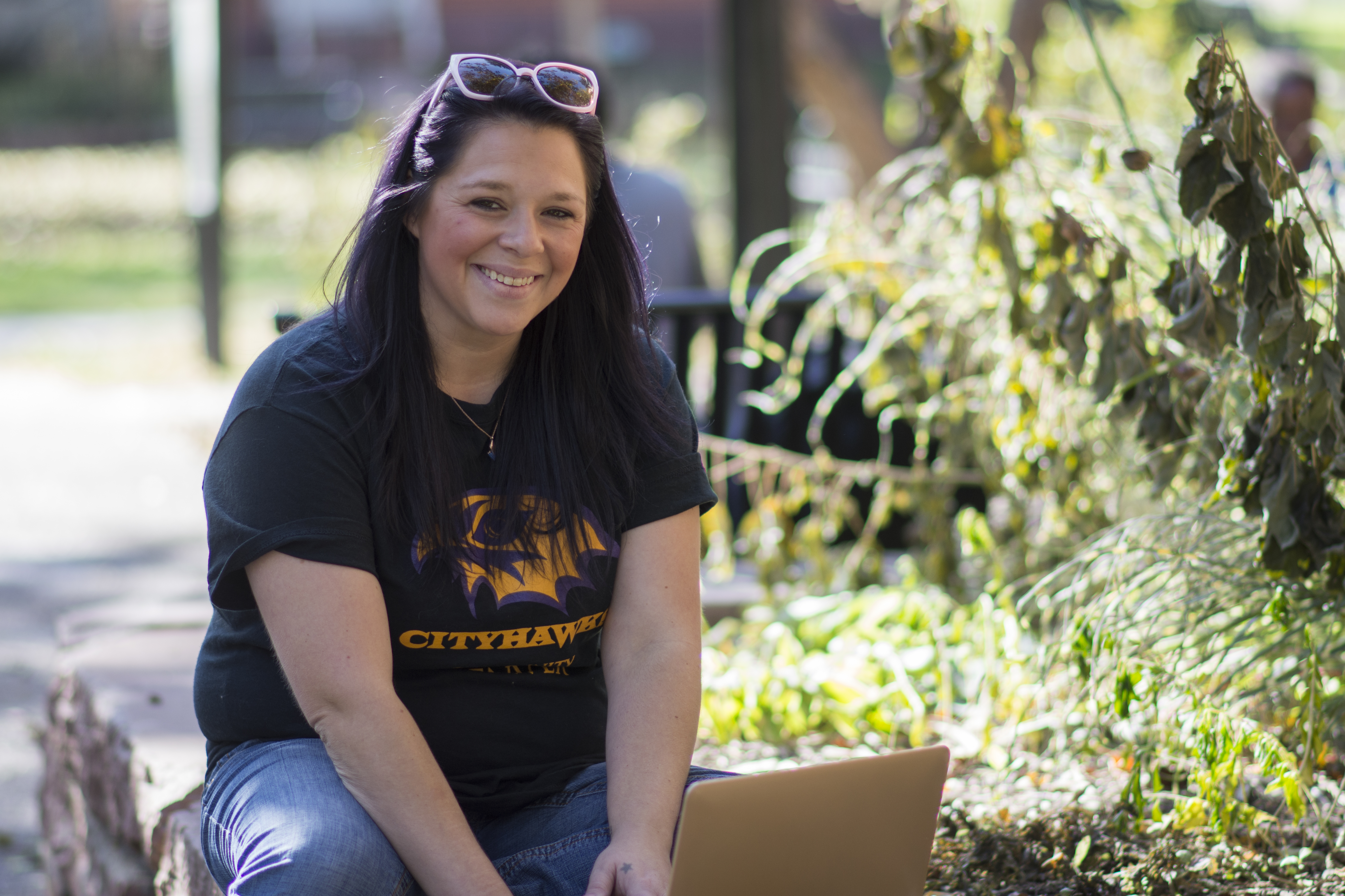 white female college student sitting outside smiling