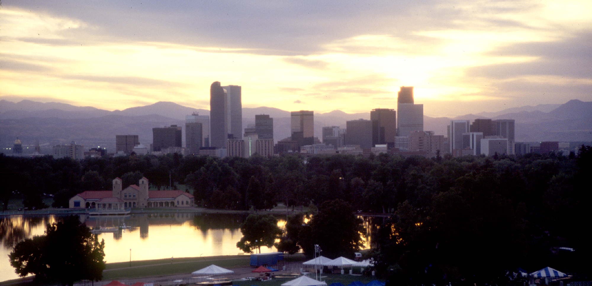 Downtown Denver and mountains from City Park at dusk