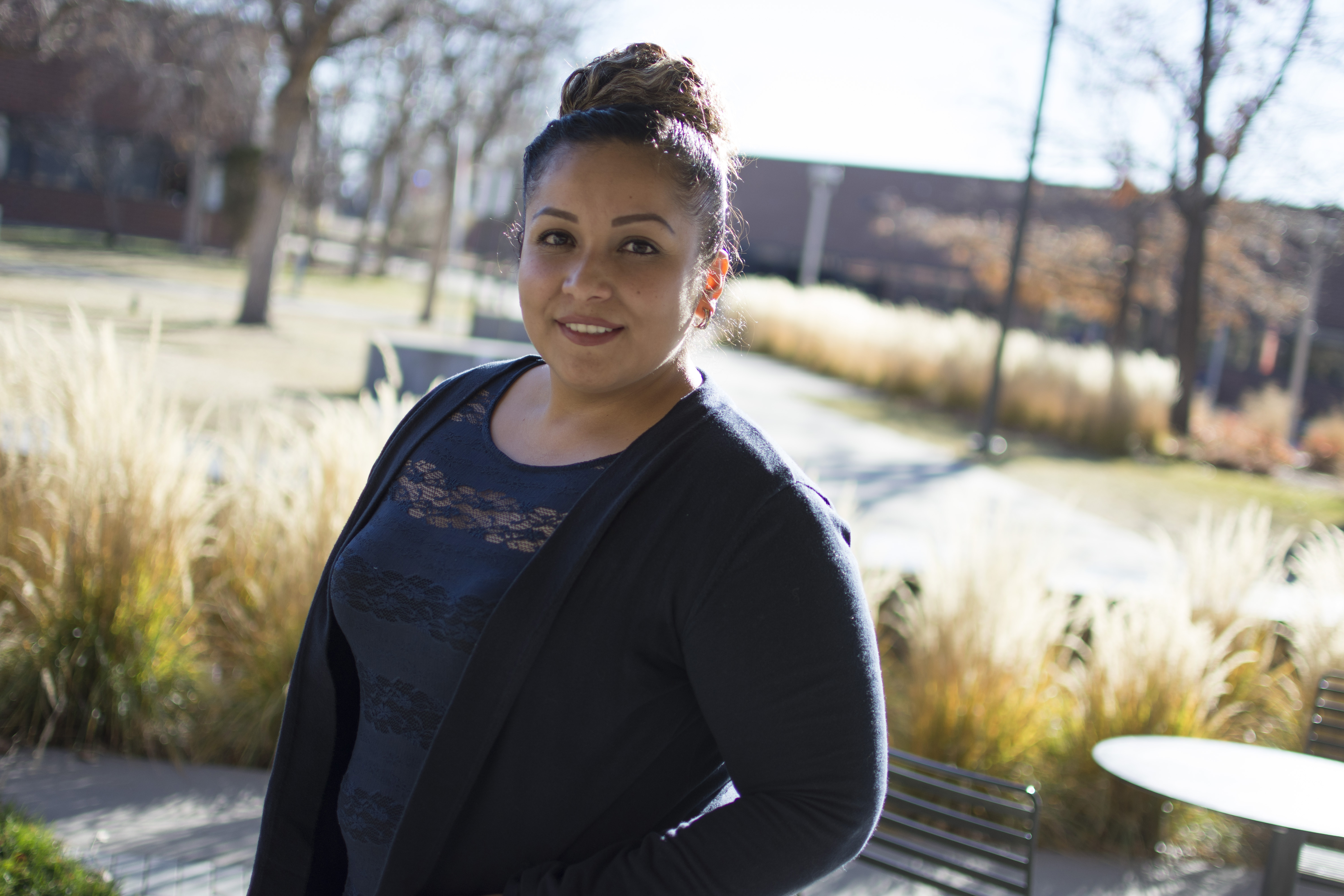 CCD Alumnus Migdalia Serrato young Hispanic women standing in a courtyard smiling