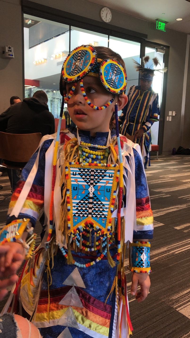 young boy dressed in colorful traditional native wear