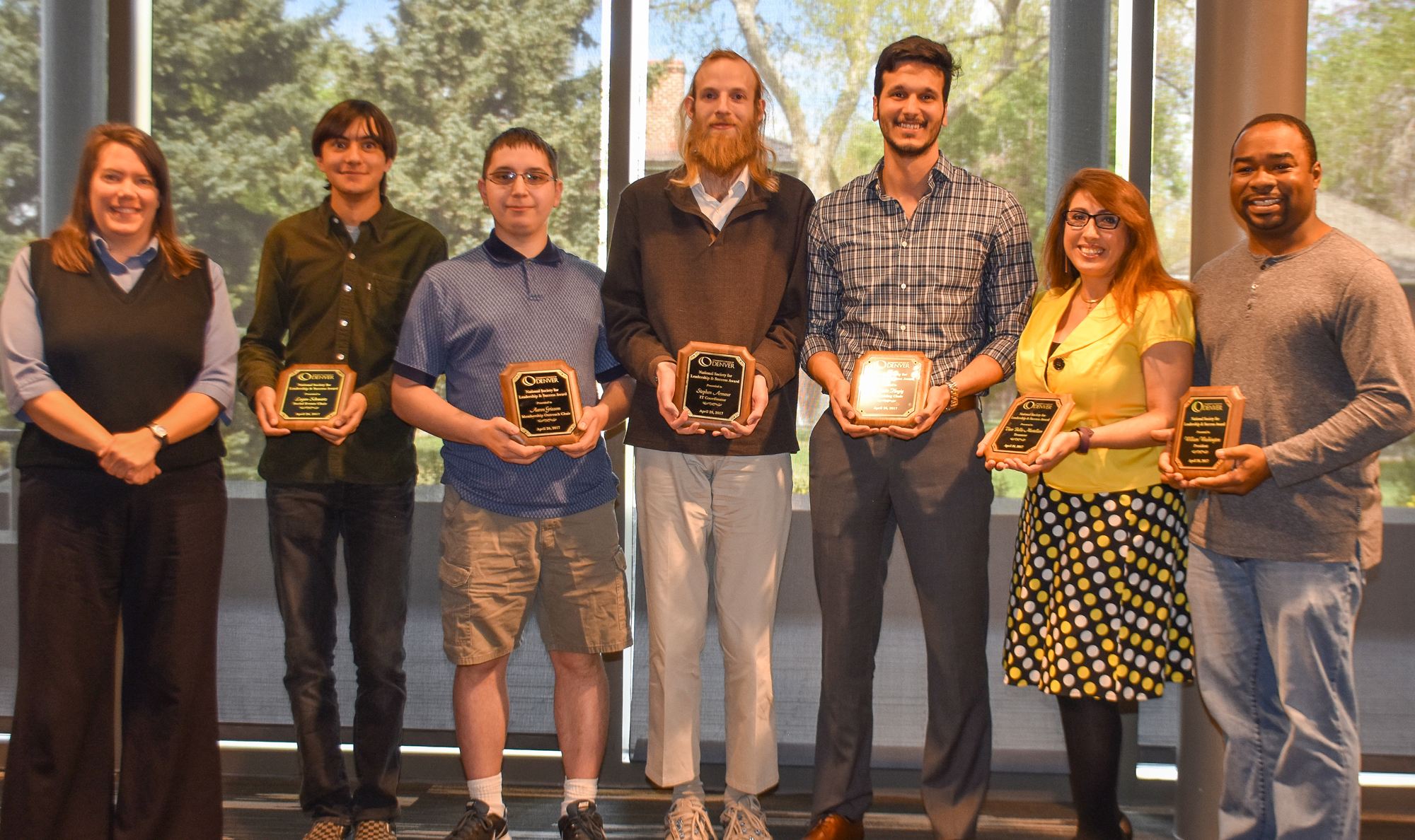 group of well dressed students holding their awards