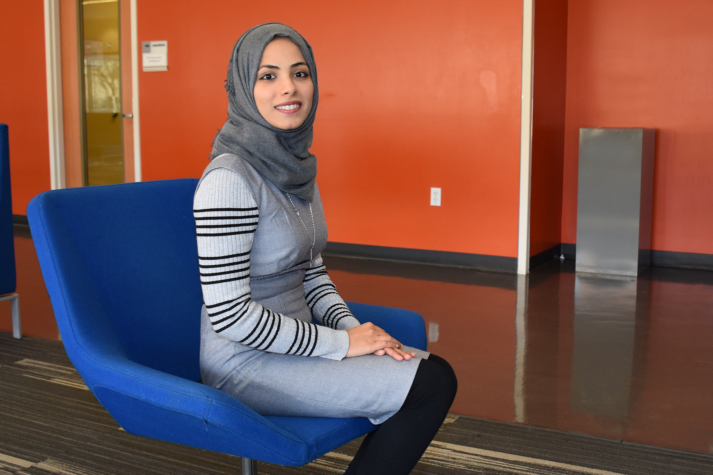 muslim female student sitting and smiling