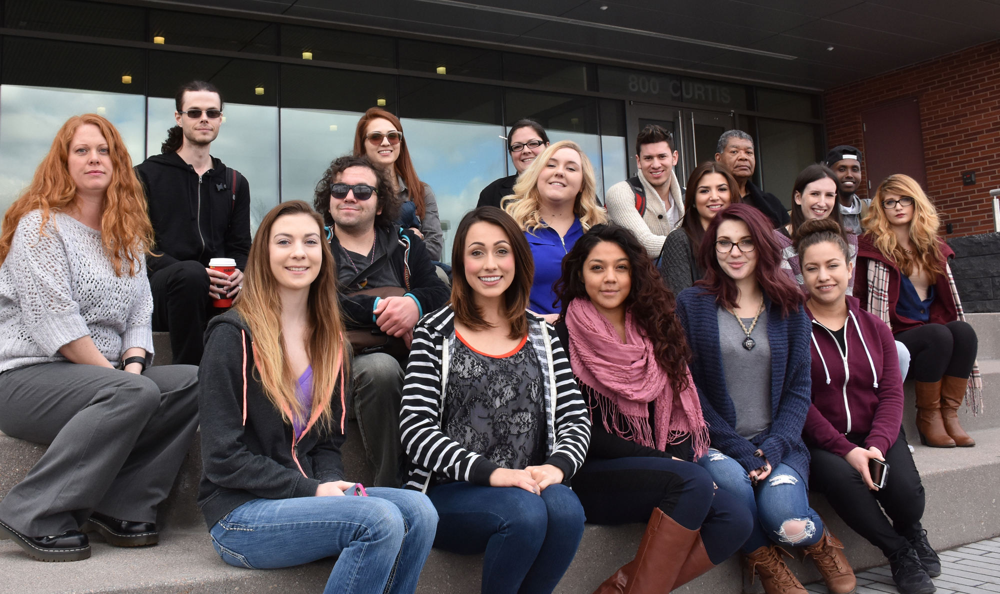 group of students sitting outside on steps