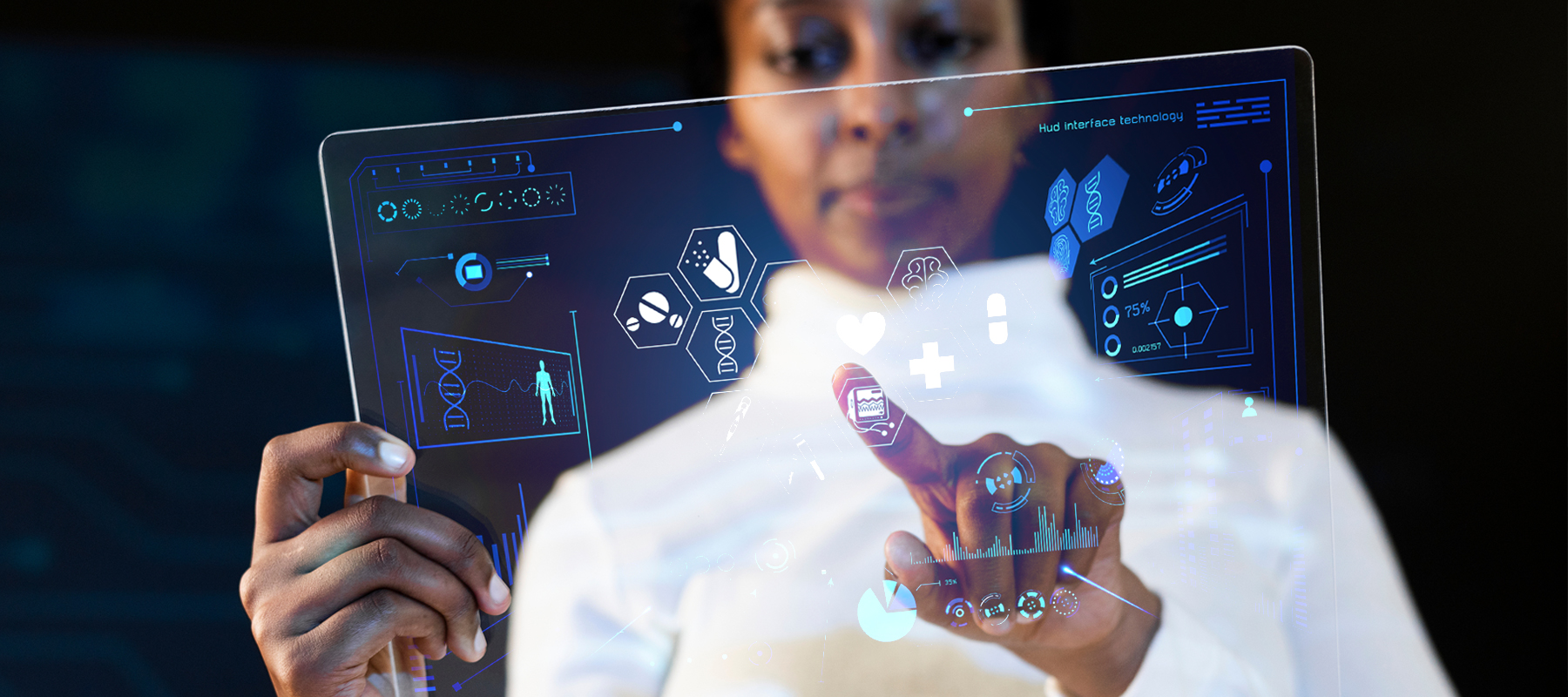 woman in white jacket touching translucent technology screen