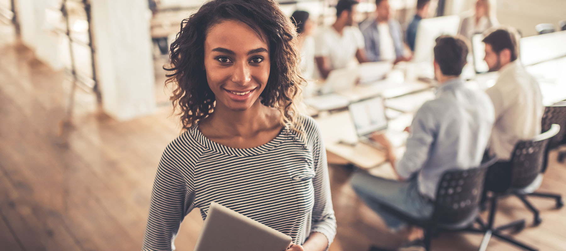 woman holding a notepad at a business meeting