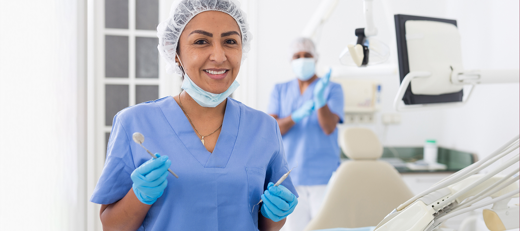 female dental hygienist in blue