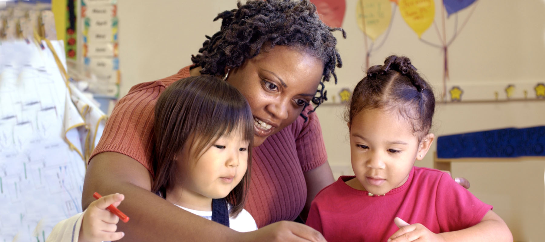 a woman works with two small children