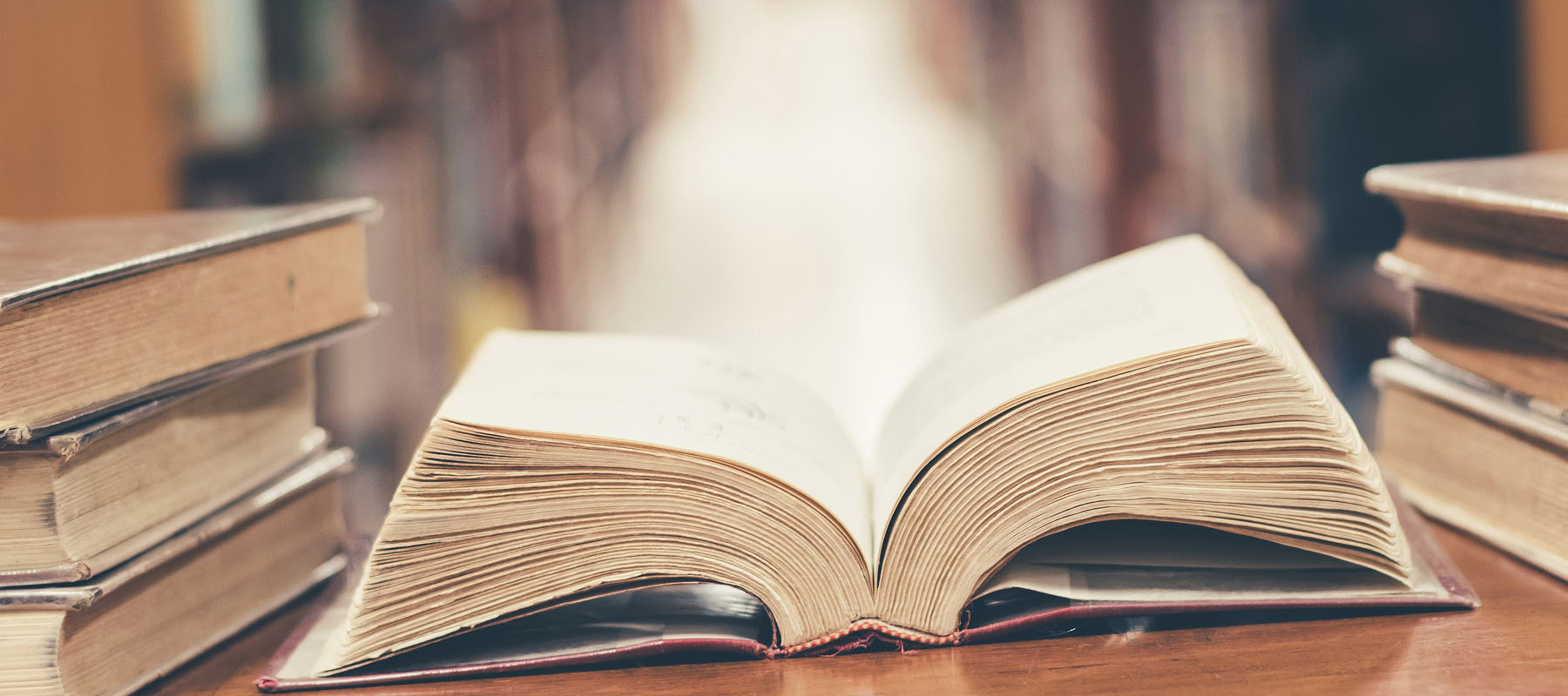 stack of books with one open