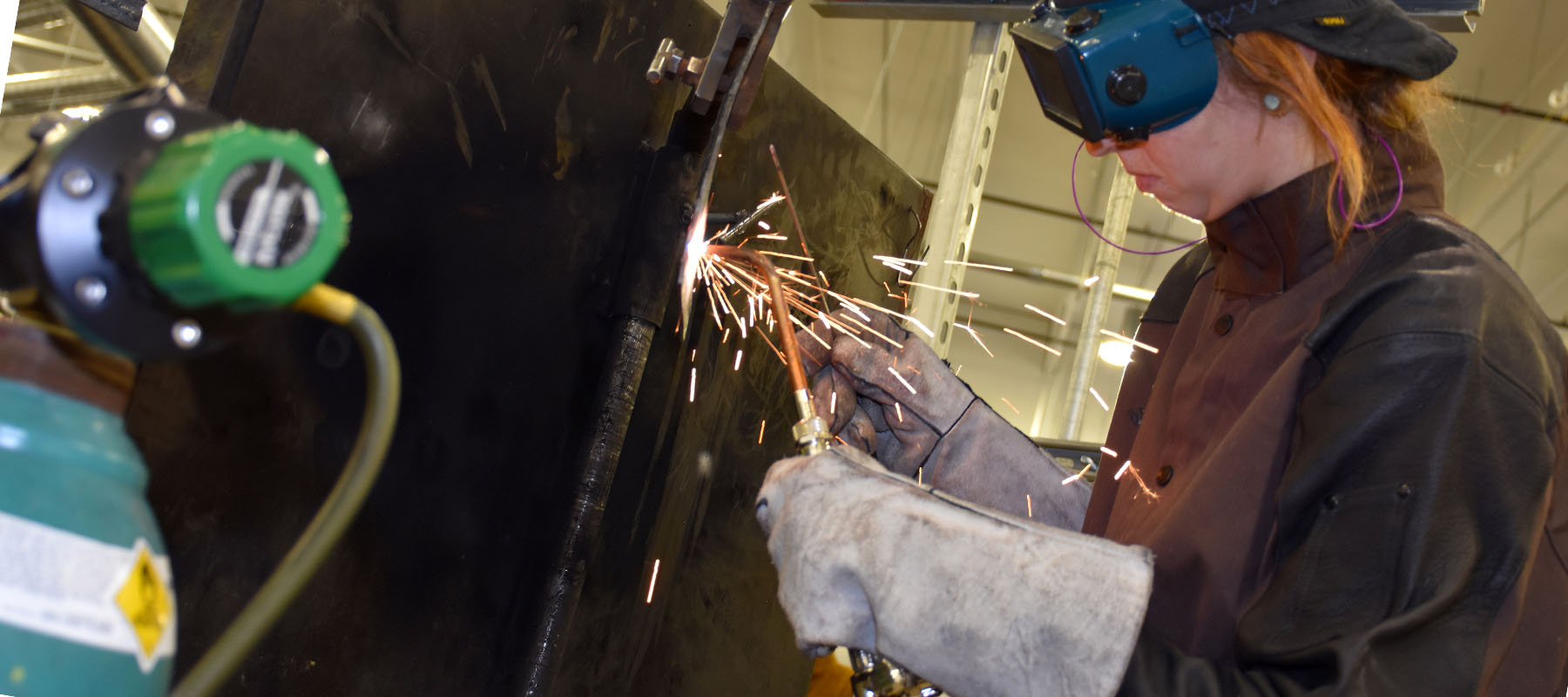 female welder with protective gear