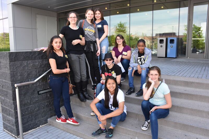 female students outside on steps