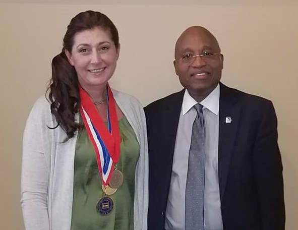 white woman and black man standing next to each other smiling