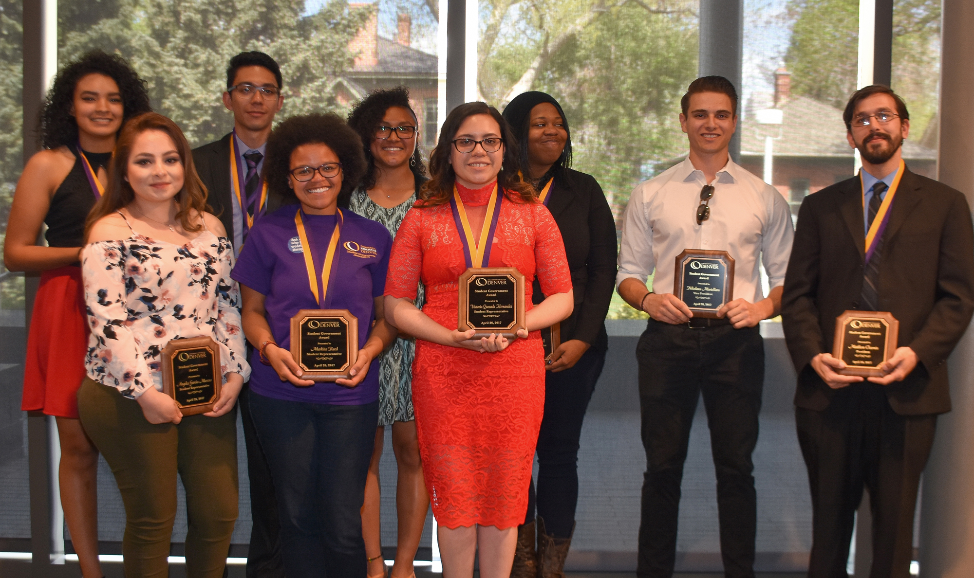 group of well dressed students holding their awards