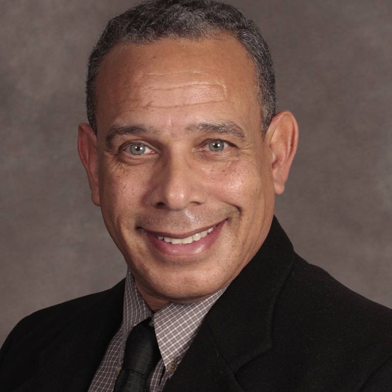 Smiling person in a suit and tie