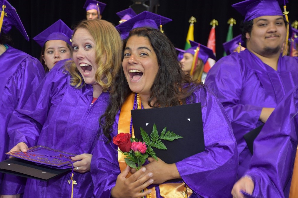 female grads smile at commencement