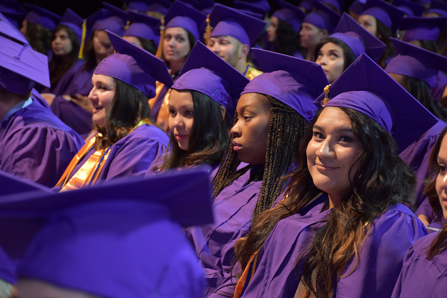 room of people with purple caps and gowns
