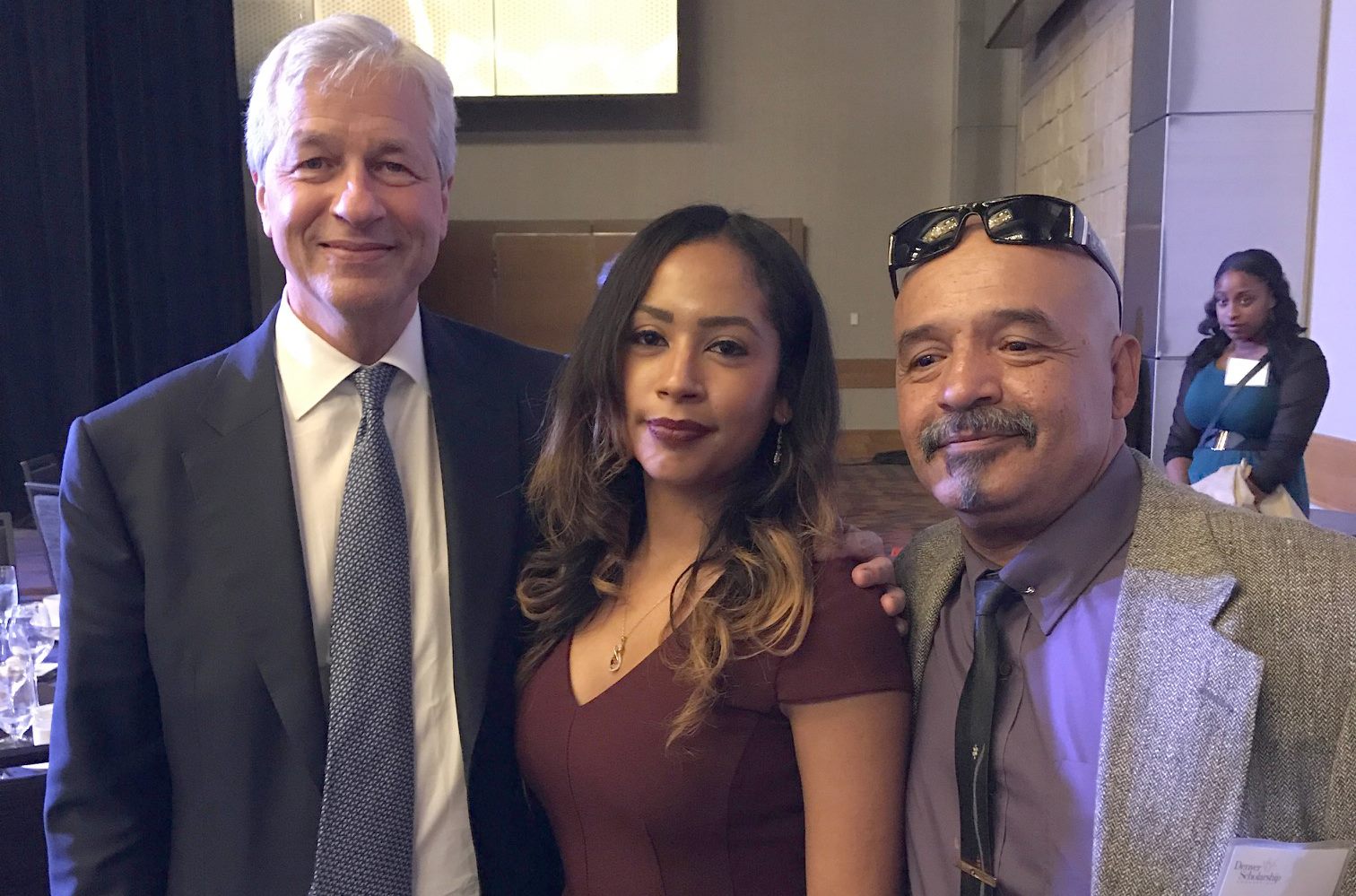 a white man and Hispanic woman and man standing together smiling