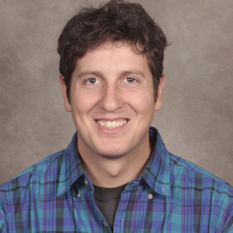 Smiling man in a plaid shirt