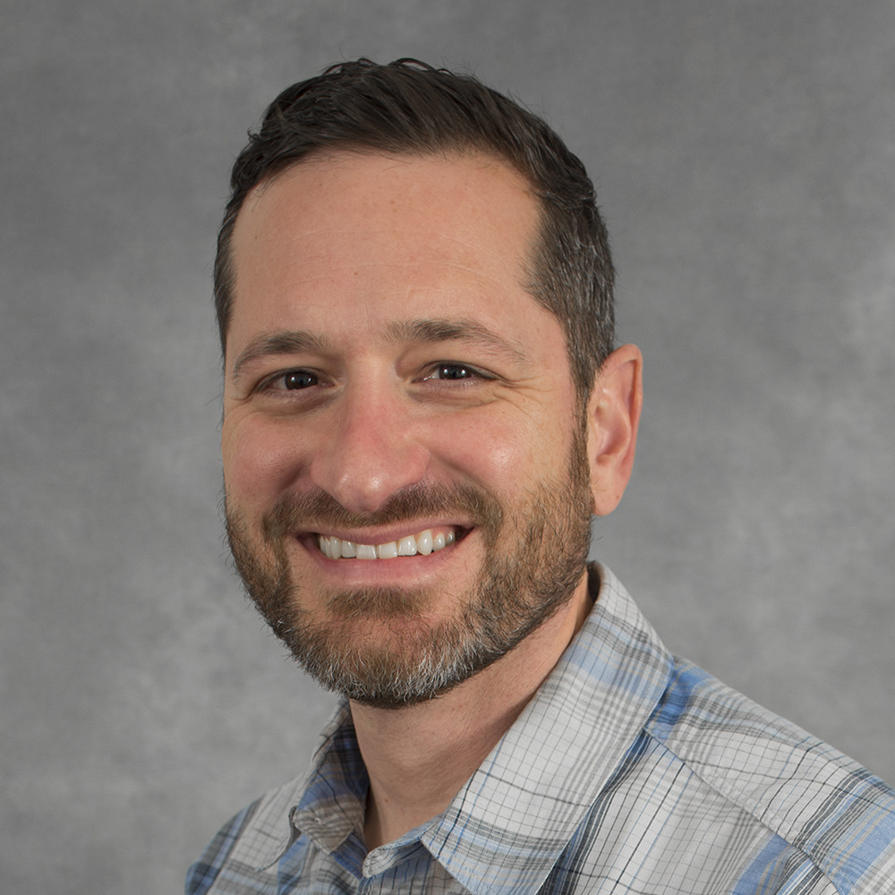 white man with brown hair and short beard smiling